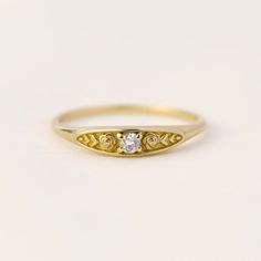 a yellow gold ring with three diamonds on it