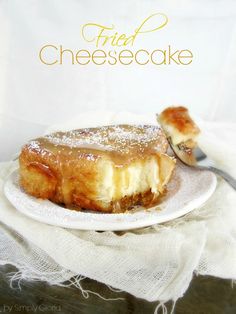 a piece of cheesecake sitting on top of a white plate next to a fork