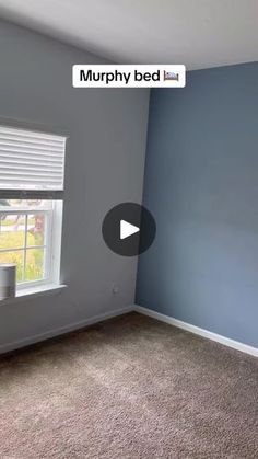 an empty bedroom with blue walls and carpet