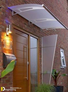 a door with an awning over it next to a potted plant