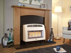 an electric heater sitting in front of a fireplace