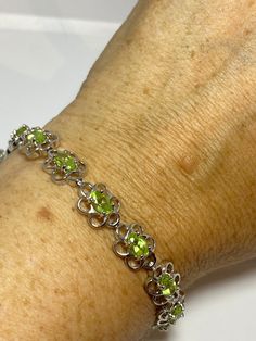 This Peridot bracelet is very lively and bright. The stones are deep colors and well matched. The sterling silver is plated with rhodium to protect the bracelet from tarnish and give the appearance of white gold. 7.5 inches My jeweler can shorten it for a $20 fee All jewelry is shipped in a nice gift box. Check out our over a THOUSAND great reviews Engraving is $4 per letter and is not always perfect depending on the piece. It can take a few days if the jeweler is busy. This is payable to Paypal Modern Green Gemstone Bracelets, Sterling Silver Bracelet With Green Gemstone, Green Sterling Silver Bracelet With Polished Finish, Green Round Sterling Silver Bracelet, Green Oval Sterling Silver Bracelets, Green Oval Sterling Silver Bracelet, Elegant Green Sterling Silver Jubilee Bracelet, Green Sterling Silver Bracelets With Polished Finish, Oval Green Sterling Silver Bracelet