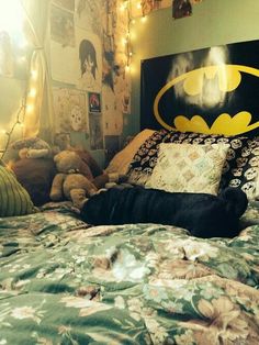 a batman bed with stuffed animals and lights on the headboard in front of it