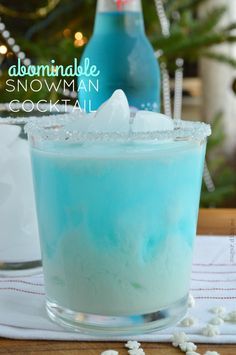 a blue and white drink sitting on top of a table next to a christmas tree