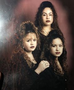 three women standing next to each other in front of a mirror