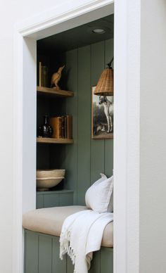 a room with green painted walls and shelves