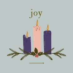 three candles with the word joy written on them and holly branches in front of them