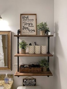 the bathroom is decorated in white and has two shelves with plants on top of them