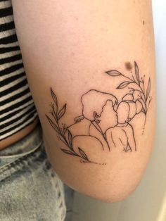 a woman's leg with a tattoo on it that has an elephant and flowers