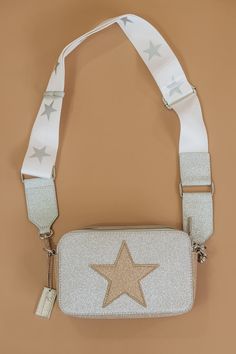 The idyllic casual bag to style with limitless looks! Compact crossbody bag with an all white design. Gold star engraving. Single top zip closure. Silvertone hardware. One inside zip pocket. Adjustable sporty star strap design.SIZE Removable, adjustable crossbody strap, 12" to 24" drop 8"W x 5"H x 2.5"D Packaged with love and shipped from our warehouse in Wilmington, Ohio Vintage Havana Purse, Star Purse, Teenager Birthday Gifts, Bday Wishlist, Preppy Bags, Teenager Birthday, Casual Purse, Zach Bryan, Aesthetic Pastel