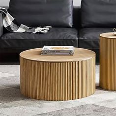 two wooden tables sitting next to each other in front of a couch