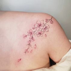 a woman's back with flowers on it