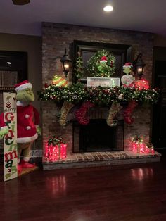 christmas decorations in front of a fireplace with lights and presents on the mantels