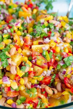 a colorful salad is in a glass bowl