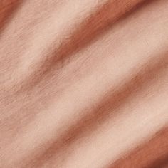 a close up view of the fabric in brown and pink tones, with some folds