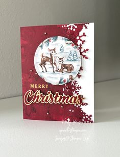 a merry christmas card with deer and snowflakes on the bottom, in front of a white background