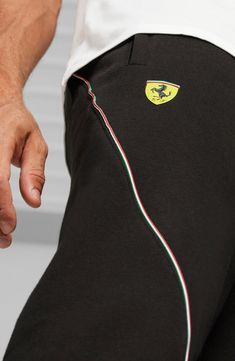 Bring motorsport style to your everyday look in these fleece joggers featuring the Scuderia Ferrari shield and the PUMA logo on either leg. Elastic/drawstring waist Front zip pockets 66% cotton, 34% polyester Machine wash, dry flat Imported Sportswear Joggers With Logo Detail For Jogging, Black Sporty Sweatpants With Logo Detail, Sporty Black Joggers With Logo Detail, Black Sports Sweatpants With Logo Detail, Athleisure Joggers With Logo Detail For Sports, Black Logo Detail Sweatpants For Sports, Black Sweatpants With Logo For Sports, Puma Logo, Scuderia Ferrari