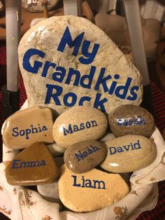 a basket filled with rocks that say my grandkids rock and names on them