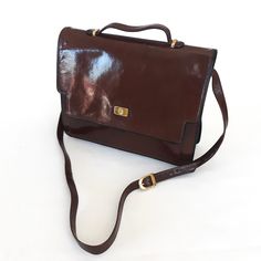 Vintage Astor leather handbag - Brown Vintage  Crossbody Purse - Satchel Style Shoulder Bag. DESCRIPTION: - Bag has a goldtone clasp fastener.  It closes/locks safely with an easy push, and it opens/unlocks with a pull trigger.  Interior has a large expendable front slip pocket.  Main part of the bag has two expandable compartments.  One has a zippered pocket and the other has a slip pocket.  Lined with Astor logo fabric. - Material: Brown leather, fabric lining and goldtone hardware - Brand: Astor - Style: Satchel/Shoulder SIZE/approx. measurements:  12 3/4" wide x 10" high (handle not included) x 1 3/4 to 4 1/2" (when expended) VINTAGE CONDITION: Excellent condition.   Lining is in extremely clean, like new condition.  All corners and edges are without scuffs and signs of wear. PLEASE NO Formal Leather Briefcase With Hasp Closure, Vintage Satchel Bags For Work, Formal Leather Bag With Hasp Closure, Brown Satchel With Hasp Closure For Formal Occasions, Vintage Bags With Detachable Strap For Work, Formal Crossbody Satchel With Leather Lining, Vintage Top Handle Bags For Work, Formal Leather Shoulder Bag With Hasp Closure, Formal Brown Satchel With Leather Lining