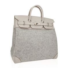 Guaranteed authentic rare Hermes HAC 40 bag featured in Gris Clair Todoo Feutre (Wool) and Craie Togo leather.A chic and masculine combination for this rare Hermes classic bag.Beautiful light gray and Craie combination this tote bag is neutral perfection for everyday to travel wear. This Hermes Hac bag is accentuated with crisp palladium hardware.There is a mark on the front flap - please see image.Comes with lock, keys and clochette and sleeper.The HAC (Haut à Courroies) is an extremely rare an High-end Epsom Leather Tote Bag, Luxury Textured Leather Bags, Designer Beige Bags With Palladium Hardware, Beige Bags With Leather Handles For Everyday Luxury, Designer Bags With Leather Handles In Epsom Leather, Everyday Luxury Beige Bags With Leather Handles, Everyday Luxury Epsom Leather Textured Bags, Chic Epsom Leather Bags With Handles, Beige Shopping Bags With Palladium Hardware