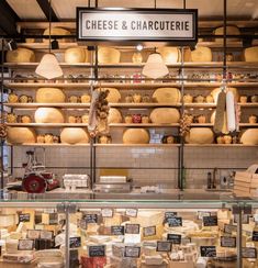 the cheese and charcuterie shop is stocked with lots of cheese