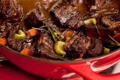 beef and vegetables cooking in a red pot