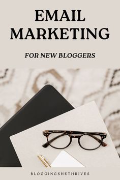 an email marketing guide for new bloggers with glasses, notebook and pen on top