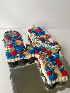 two decorated cupcakes sitting on top of each other