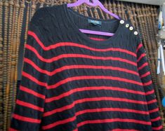 "♥ Designed by RALPH LAUREN in the late 90's. ♥ Striped in black and red. ♥ Made of 58% Cotton + 42% Viscose. ♥ Adorned with 4 shiny gold tone buttons - stamped by the Ralph Lauren logo. ♥ Long sleeves. ♥ Shrunken cuffs and hemline. ♥ Rounded neckline - easy to put on and take off. ♥ Was rarely in use - beautiful condition!  * Please study the pictures AND measurements as they form an integral part of the description.* Here are the measurements (taken lying flat): Underarm to underarm: 23\" (stretching up to 26\"). Sleeves: 24.5\" . Shoulder to hem: 28\".  Mails from a smoke-free home  Thanks for looking (:" Ralph Lauren Knit Sweater, Ralph Lauren Knit, Sweater Striped, Ralph Lauren Logo, Lauren By Ralph Lauren, Women Pullover, Put On, Sweater Outfits, Pullover Sweaters