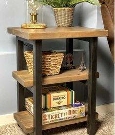 a wooden shelf with books and baskets on it next to a plant in a vase