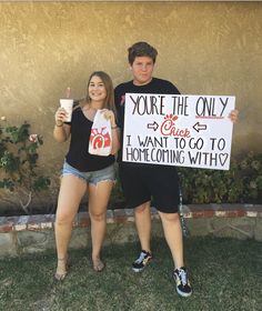 two people holding up signs in front of a building that says, you're the only one i want to go to home cooking with