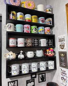 the shelves are filled with coffee cups and mugs