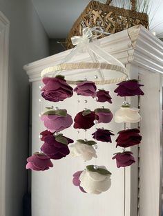 a wind chime with flowers hanging from it's sides