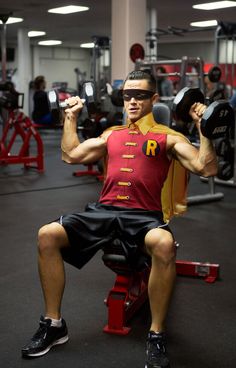 a man squatting on a bench in a gym with the caption, joseph goffini leviti doing shoulder presses