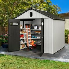 an outdoor storage shed with the door open and shelves full of toys in front of it