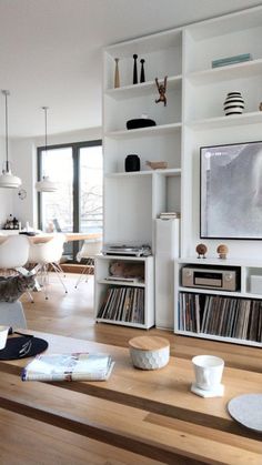 a living room filled with furniture and bookshelves