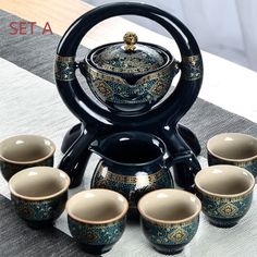 a tea set with six cups and a kettle