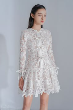 Quinnley Drop Waist Round Neck Lace Mini Dress | MEAN BLVD Long Sleeve Delicate Lace Dress For Formal Occasions, Elegant Lace Patchwork Mini Dress For Formal Occasions, Feminine Mini Dress With Lace Sleeves For Formal Occasions, Feminine Mini Dress With Lace Sleeves For Wedding, Lace Top Mini Dress For Wedding, Elegant Mini Dress With Lace Patchwork For Formal Events, Formal Feminine Mini Dress With Lace Sleeves, Elegant Dress With Lace Top And Fitted Bodice, Formal Dress With Lace Top