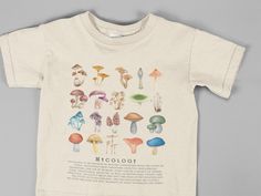 Embrace your love for nature with this Cool Mushroom Shirt! Perfect for hiking, camping, outdoor adventures, and of course, wildlife watching or comfy home lounging! This shirt features a botanical-inspired design that any nature fan will adore. It's ideal for expressing your passion for mushrooms and the great outdoors. Looking for the ideal gift? Our shirts are just what you need! Whether it's for a birthday or Christmas, this shirt is perfect for both men and women. Crafted from the highest q Graphic Tee Shirt With Mushroom Print, Nature-inspired Cotton Tops With Graphic Print, Cotton T-shirt With Mushroom Design For Fall, Relaxed Fit Short Sleeve Shirt With Mushroom Print, Cotton Short Sleeve Tops With Mushroom Design, Cotton Short Sleeve Shirt With Mushroom Design, Clothing Cottagecore, Retro Mushroom, Mushroom T Shirt