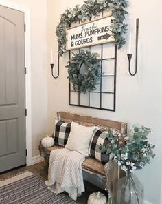 the entryway is decorated with greenery and pumpkins