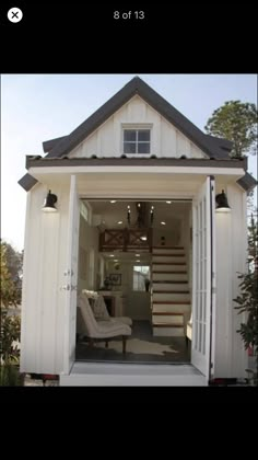 the inside of a small white house with stairs leading up to it's second floor