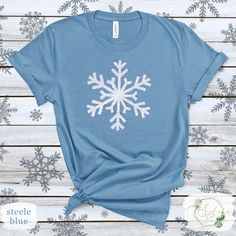 Light up your winter wardrobe with our Glitter Snowflake Shirt. This sparkly and stylish top is perfect for holiday events or adding a touch of glamour to your everyday winter attire. Celebrate the winter season in style with our Glitter Winter Shirt. Featuring a sparkling design, this festive top is ideal for holiday parties or adding some glam to your winter look. Handmade with love, Stacia <3  *We offer custom prints on all types of products! 🛍️ Check out some other options in my store!! https://scalaco.etsy.com/ 💕 Follow @scala_co on socials for more inspiration! 🌟 ----------------------------------------------------------------- ✨ Style Essentials! ✨ ✓ Handmade, designed and printed in the USA with love! 🇺🇸 ✓ High quality material with durable print. ✓ Super soft, stylish, and ec Winter Holiday Cotton Shirt, Casual Winter Party T-shirt, Festive Winter Crew Neck Shirt, Crew Neck Shirt For Winter Festive Occasion, Festive Holiday Cotton Tops, Cotton Glitter Print Party Tops, Party Cotton Tops With Glitter Print, Cotton Party Tops With Glitter Print, Winter Glitter Long Sleeve Tops