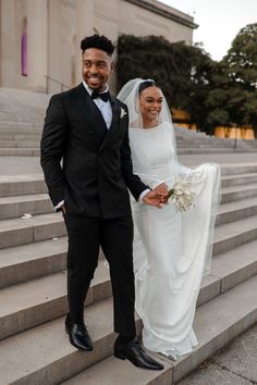 a bride and groom are standing on the steps