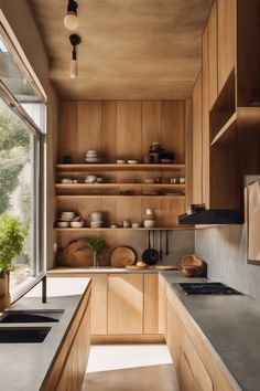 Modern kitchen with wooden cabinets, concrete countertops, a large window, and open shelves displaying dishes and plants. One Wall Galley Kitchen, Mid Century Galley Kitchen, Kitchen Entryway Ideas, Ikea Galley Kitchen, Galley Kitchen Renovation