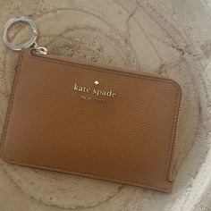 Tan Never Used Wallet Beige Everyday Coin Purse, Chic Brown Card Holder For Everyday Use, Kate Spade Card Holder For Everyday Use, Trendy Kate Spade Travel Wallets, Trendy Kate Spade Wallets For Travel, Kate Spade Bifold Coin Purse, Kate Spade Coin Purse With Card Slots, Everyday Beige Kate Spade Wallet, Kate Spade Everyday Bifold Bag