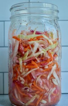 a glass jar filled with sliced up vegetables