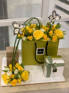 two green bags with yellow flowers and butterflies on them are sitting next to each other