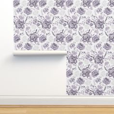 a white wall with purple flowers on it