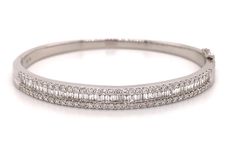 This stunning white gold bangle bracelet is crafted with 2.14 carats of twinkling baguette and round-cut diamonds. Showcase your unique style and luxury with this divine bracelet, crafted for a dazzling finish. Metal: 18K White GoldDiamond Shape , Weight: (70) Round Cuts 1.09ctw, (48) Baguette Cuts 1.05ctwDiamond Total Weight: 2.14ctwBangle/Wrist Width: 5.7cm x 4.8cmBangle Weight: 6mm White Gold Bangle, Diamond Bangles Bracelet, Gold Bangle, Gold Bangle Bracelet, Diamond Bangle, Baguette Cut, Round Cut Diamond, Gold Bangles, White Gold Diamonds