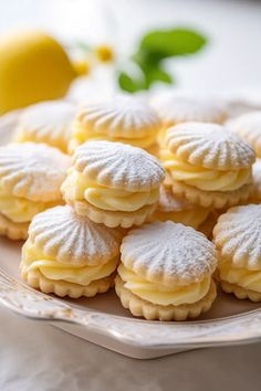 a plate full of lemon shortbreads with powdered sugar on the top and bottom